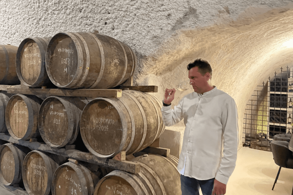 Wineland Sommelier Yannis tasting white wine during wine tour in Hatzidakis winery in Santorini