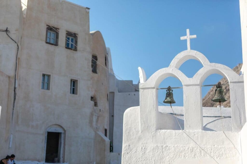 A detail shot of bells in a whitewashed bell tower in Emporio, Santorini.