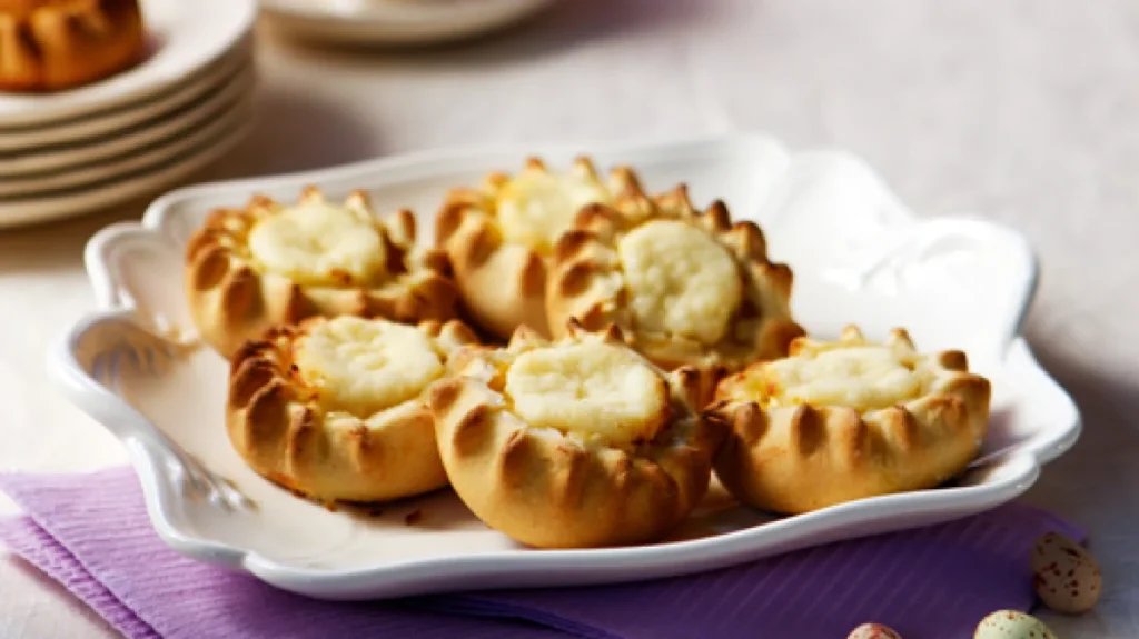 Close-up of several Melitinia, traditional Santorini Easter pastries filled with cheese.