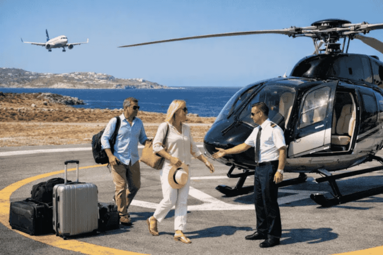 Passengers walking toward a helicopter on a helipad with luggage, preparing for a helicopter flight from Athens to Santorini, with the sea and an airplane visible in the background.