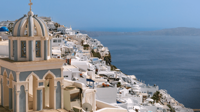 Imerovigli village in Santorini with church and panoramic caldera view.