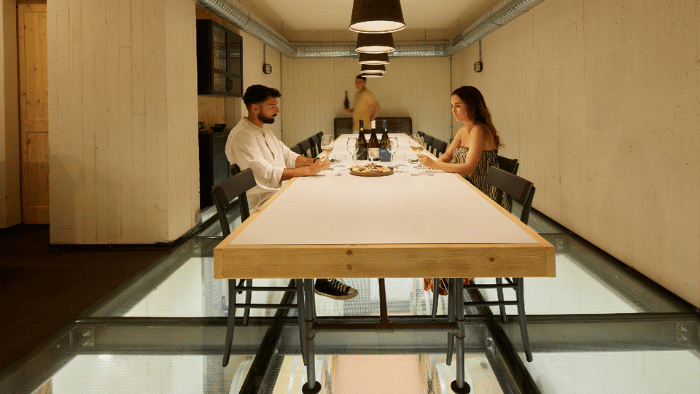 Wineland Tours Guests enjoying a wine tasting in a modern Santorini winery tasting room