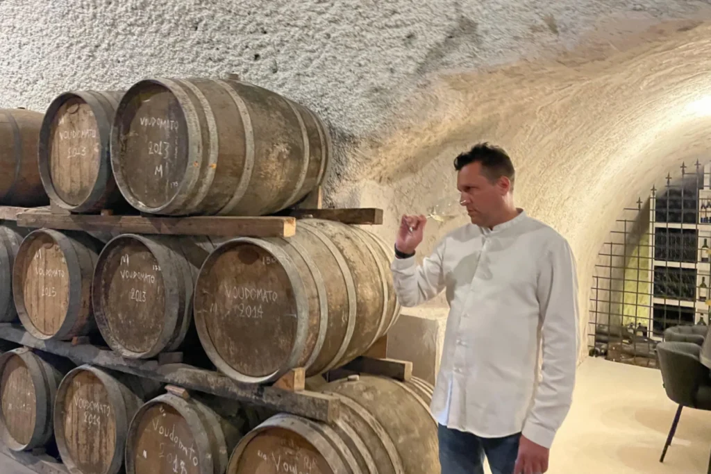 Wineland Sommelier Yannis tasting white wine during wine tour in Hatzidakis winery in Santorini